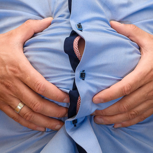 Man feeling abdominal distension