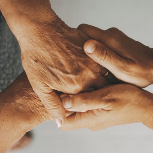 Senior person holding hands 