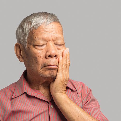 Old man facing dental pain