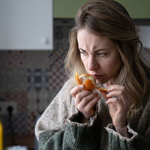 Women smelling oranges