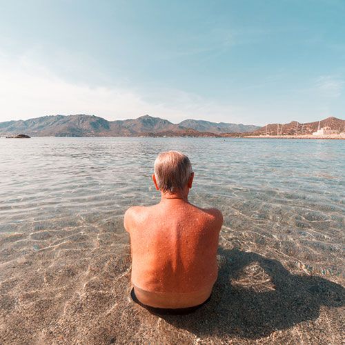 Man taking sun bath on the beach