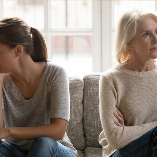 Two women sitting in anger
