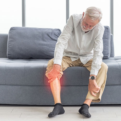 Old man having pain in legs