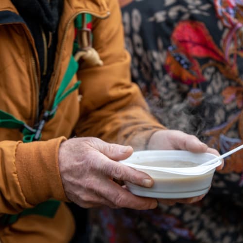 Senior person with a soup bowl
