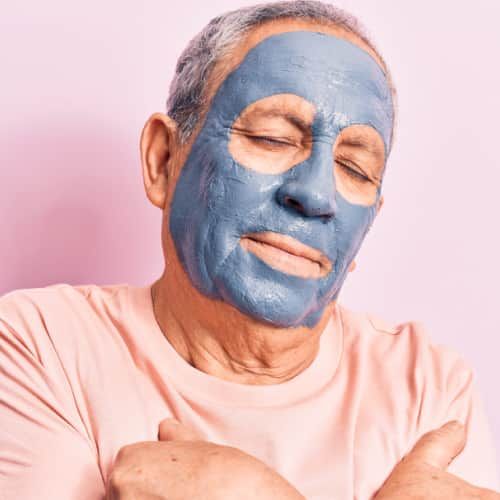 Senior man with a face mask for skincare