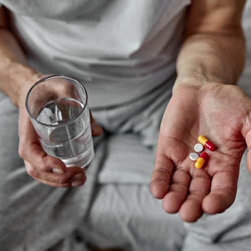 Old man taking tablets