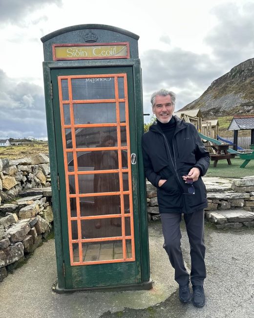 Pierce Brosnan posing for a picture with an overcoat 