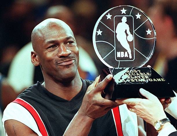 Chicago Bulls' Michael Jordan holds up the Most Valuable Player trophy which he earned in leading the Eastern Conference to victory in the NBA All-Star Game at Madison Square Garden 08 February. Jordan won his third MVP award by scoring 23 points as the Eastern Conference All-Stars beat the Western Conference 135-114